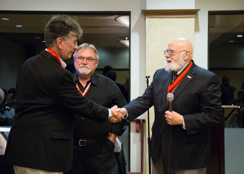 Rafael Munoz accepts his Hall of Fame Award from Frank and Bob